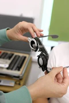 Trial frame for vision testing in a person's hands in an ophthalmology clinic Stock Photos