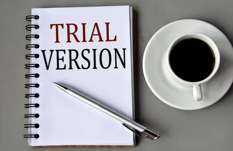 TRIAL VERSION - words on a white sheet on a gray background with a pen and a  Stock Photos