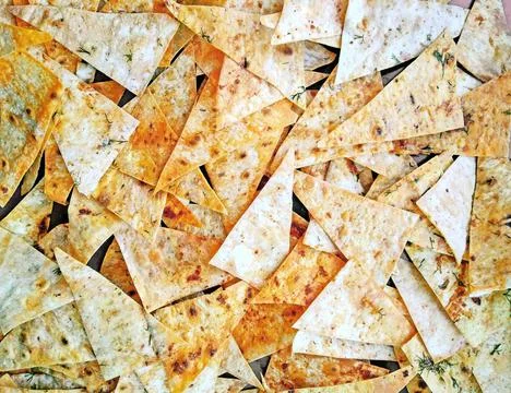 Triangle chips with spices. Fotos Stock