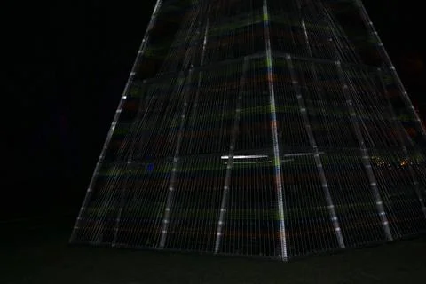 Triangle colorful structure made of lines of lights. Built pyramid out of lin Stock Photos