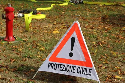 Triangle with exclamation mark and text in Italian which means CIVIL PROTECTI Stock Photos