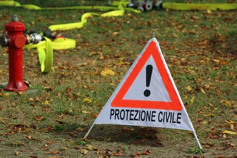Triangle with exclamation mark and text in Italian which means CIVIL PROTECTI Stock Photos