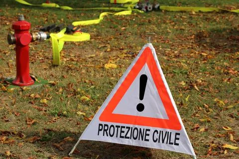 Triangle with exclamation mark and text in Italian which means CIVIL PROTECTI Stock Photos