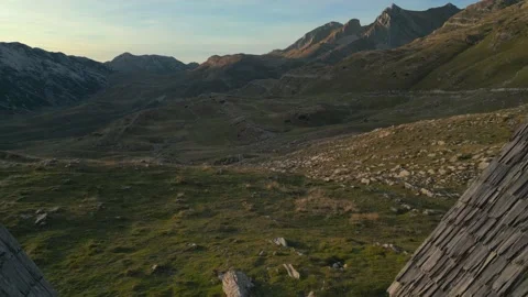Triangle huts on meadow in the mountains valley Stock Footage 232274156