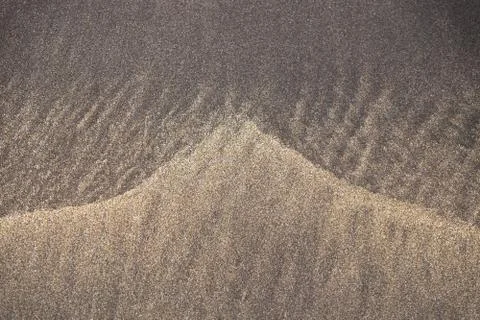 Triangle Pattern in the mixture of yellow and black sand, Costa Adeje, Teneri Stock Photos