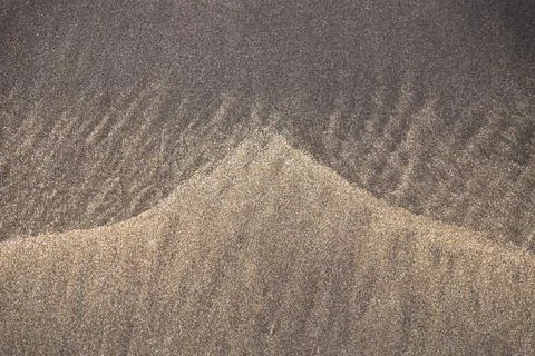 Triangle Pattern in the mixture of yellow and black sand, Costa Adeje, Ten... Stock Photos