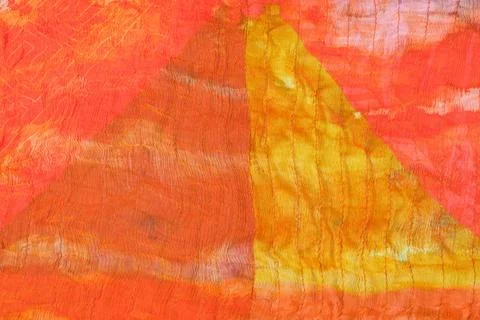 Triangle pattern on stitched orange silk batik triangle geometrical patter... Stock Photos