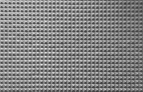 Triangle pyramid tiles pattern surface texture. Close-up of architecture inte Stock Photos