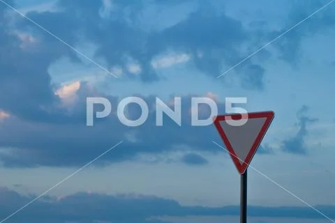 Triangle road sign on sky background Stock Photos