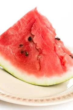 Triangle slice of watermelon on the plate isolated over white background Stock Photos