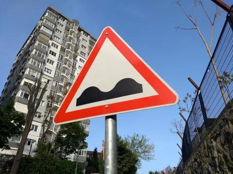Triangle speed bump sign in the city Stock Photos