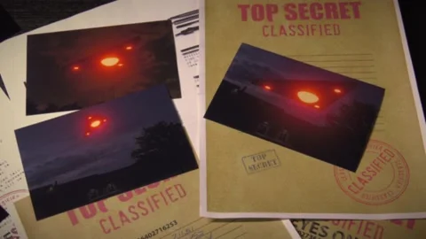 Triangle UFO files on a table with photographs Stock Footage 156364928