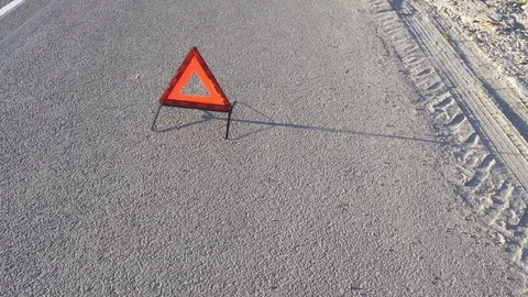 Triangle the warning triangle standing on the road Stock Footage 76825883