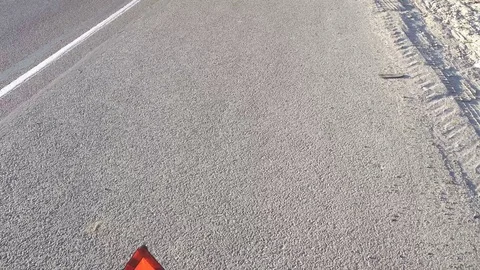 Triangle the warning triangle standing on the road Stock Footage 76830062