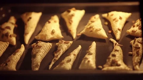 Triangles of puff pastry inside oven Stock Footage 73375964