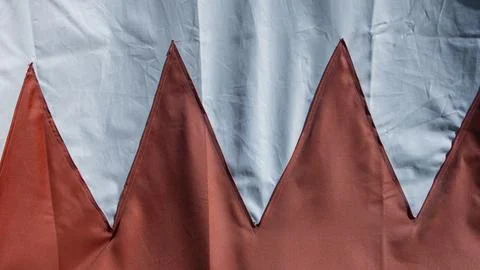 Triangles of red cloth stitched on a white tarpaulin Stock Photos