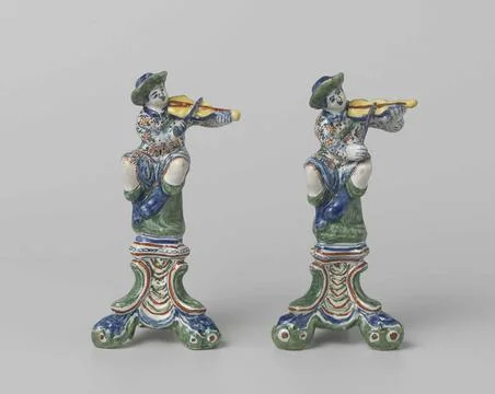 . On a triangular and three-legged pedestal is a violin man with hat. The ... Stock Photos