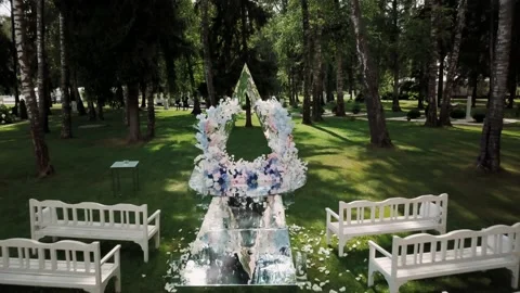 Triangular arch for registration. White benches stand in two rows Video stock 133876282