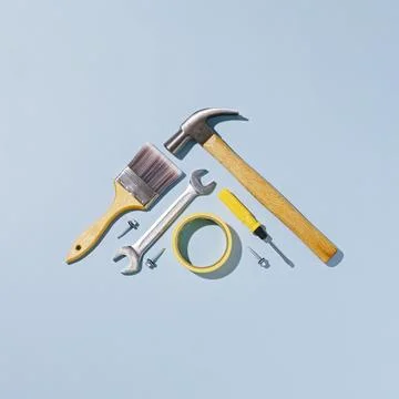 Triangular arrangement of hand tools over blue background Stock Photos