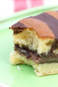 Triangular bitten chocolate cake Stock Photos