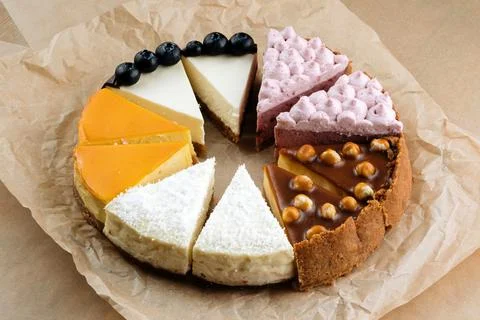 Triangular Cake Pieces Assorted Flavors, Hazelnut, Chocolate, Orange, Blueberry 스톡 사진