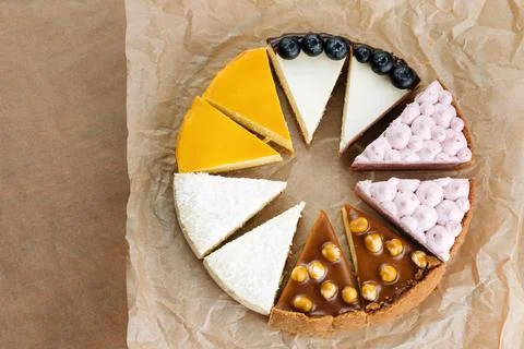 Triangular Cake Pieces Assorted Flavors, Hazelnut, Chocolate, Orange, Blueberry Photos