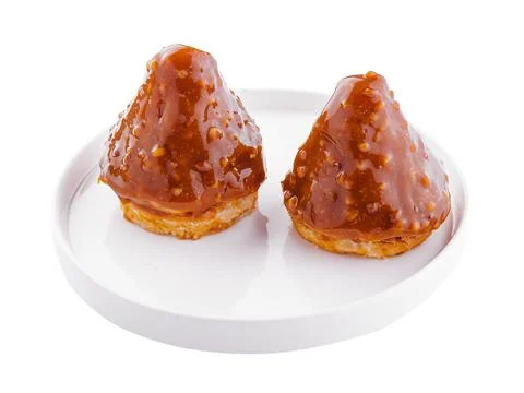 Triangular cake with toffee jam on plate Stock Photos