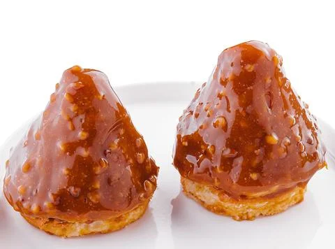Triangular cake with toffee jam on plate Stock Photos