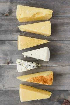 Triangular cheese chunk arranged row wooden plank. High quality and resolution 스톡 사진