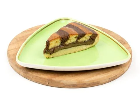 Triangular chocolate cake on green triangular plate 스톡 사진