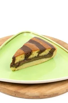 Triangular chocolate cake on green triangular plate 스톡 사진