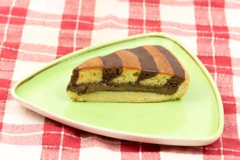 Triangular chocolate cake on green triangular plate 스톡 사진