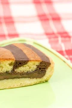 Triangular chocolate cake on green triangular plate 스톡 사진