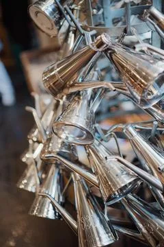 Triangular Coffee Cans Made from Metallic Steel Metal Hanging Together on D.. Stock Photos