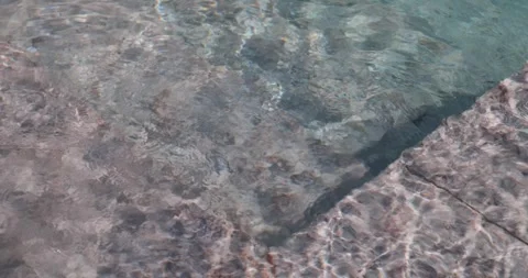 Triangular composition of stones in the shallow part of a swimming pool Stock Footage 320708886