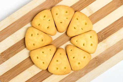 Triangular cookies folded around lie on a blackboard Stock Photos