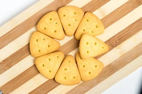 Triangular cookies folded around lie on a blackboard Stock Photos