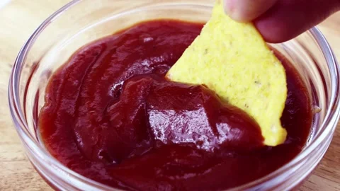 Triangular corn chips, Mexican nachos dips with tomato ketchup sauce, close up Stock Footage 235659299