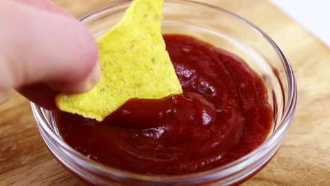 Triangular corn chips, Mexican nachos dips with tomato ketchup sauce Stock Footage 236932752