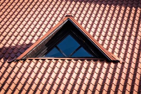 Triangular Dormer Window on Modern Metal Roof of Residential House Stock Photos