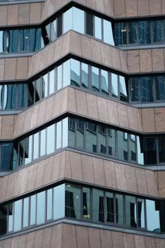 Triangular element of the facade of a modern high-rise building of glass and  Stock Photos