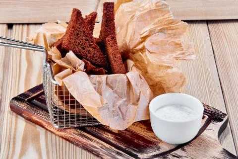 Triangular fried croutons on a wooden table Stock Photos