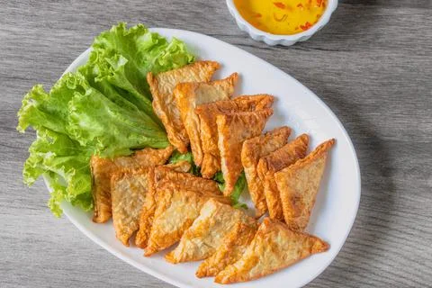 Triangular fried tofu eating with spicy dipping sauce, sweet and spicy Stock Photos