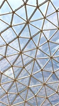 Triangular grid pattern glass ceiling reflecting urban architectural trends Stock Photos