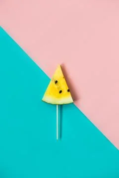 Triangular ice cream slices on a stick of ripe yellow watermelon 스톡 사진