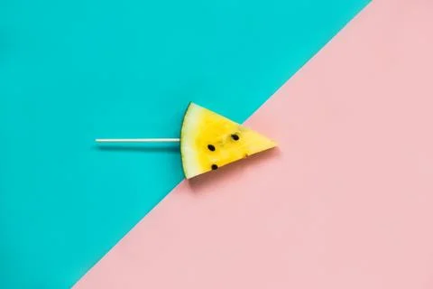 Triangular ice cream slices on a stick of ripe yellow watermelon 库存照片