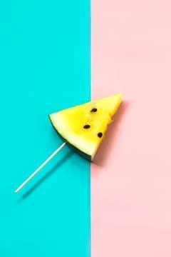 Triangular ice cream slices on a stick of ripe yellow watermelon Stockfoto's