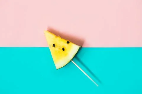 Triangular ice cream slices on a stick of ripe yellow watermelon Stock Photos