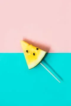 Triangular ice cream slices on a stick of ripe yellow watermelon 스톡 사진