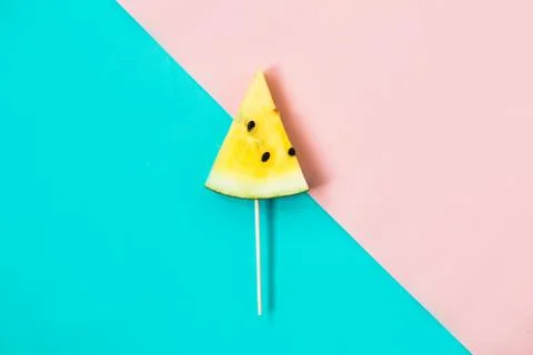 Triangular ice cream slices on a stick of ripe yellow watermelon Foto stock